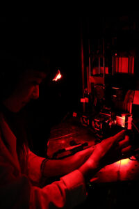 El-Quessny conducting an experiment while using a red headlamp, so as to not stimulate the mouse retina. Photo: Ray Cayetano.